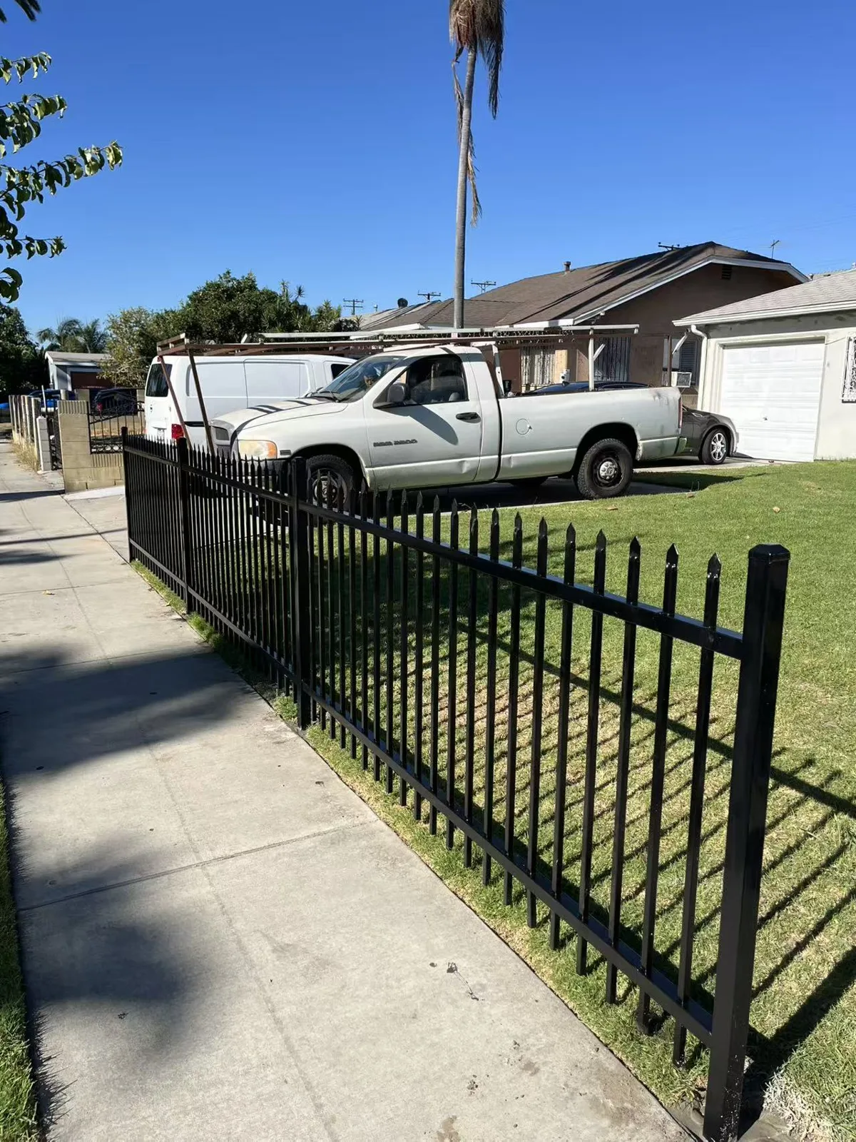 Spike-top wrought iron fence running along the sidewalk in Huntington Park, CA by Apexguard Fence