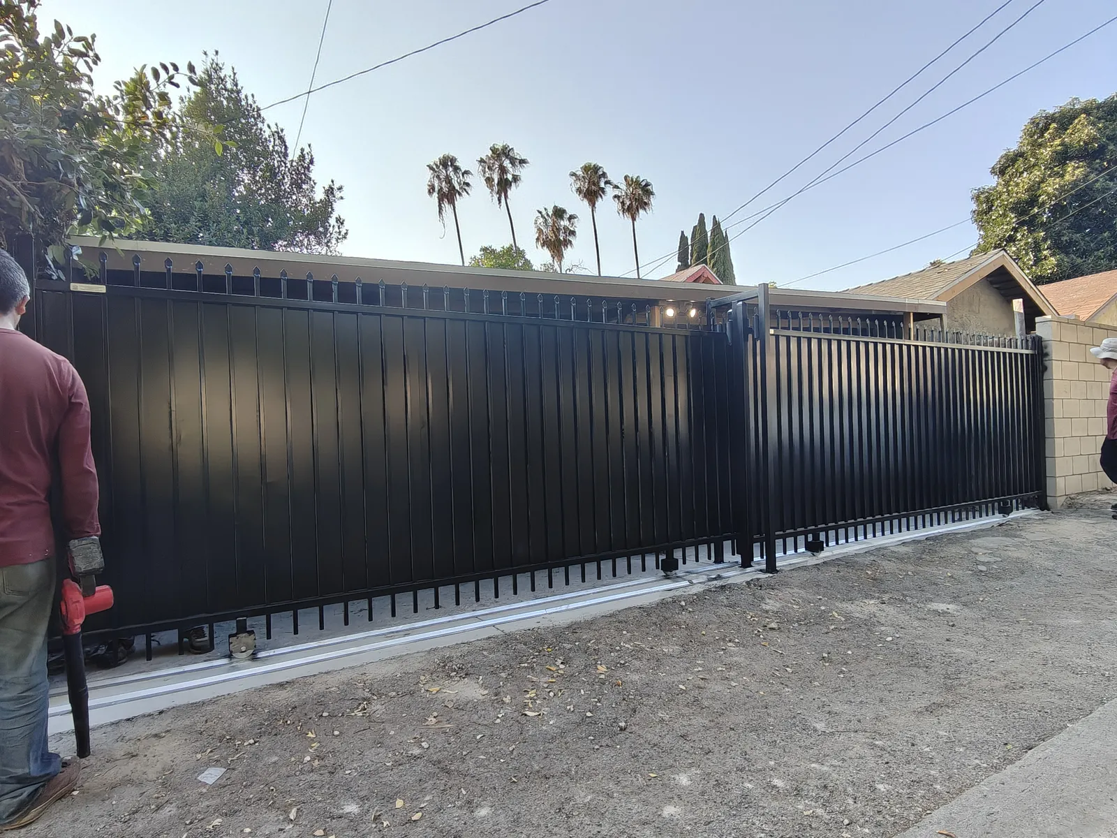 Two independent sliding driveway gates built from one 26-foot opening for two tenants in Los Angeles by Apexguard Fence