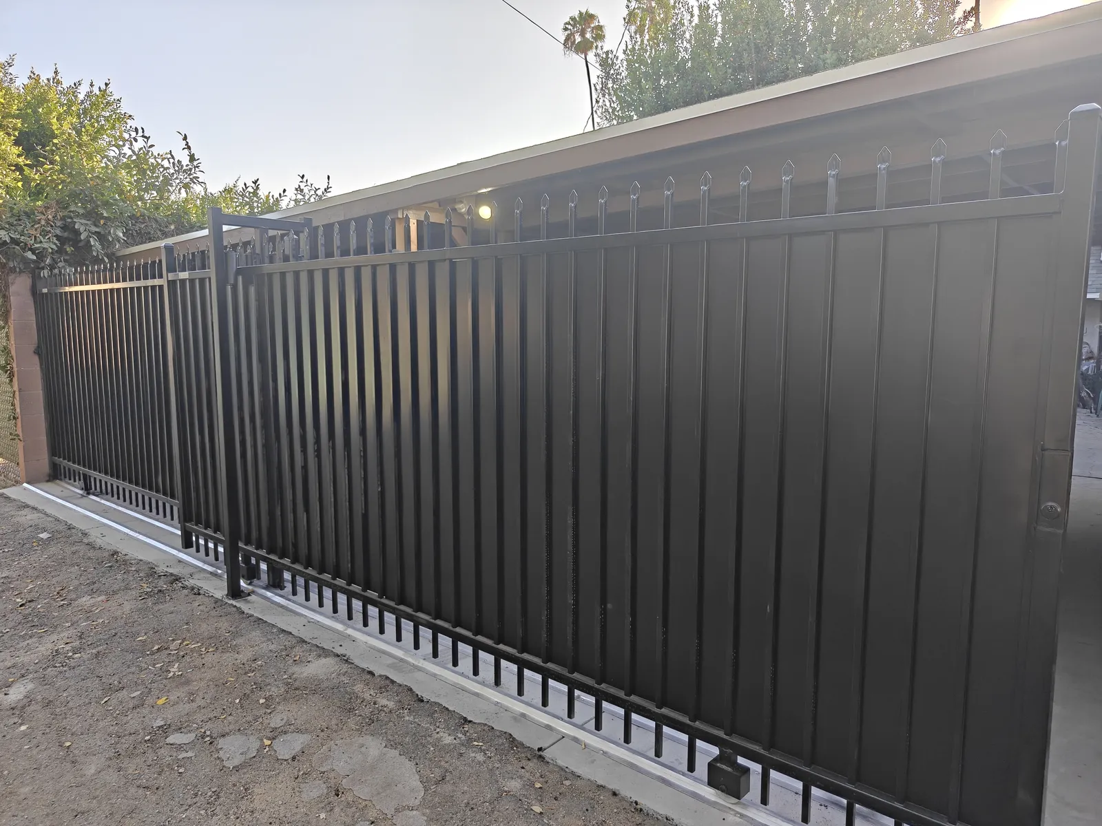 Two completed sliding security gates from one driveway opening in Los Angeles