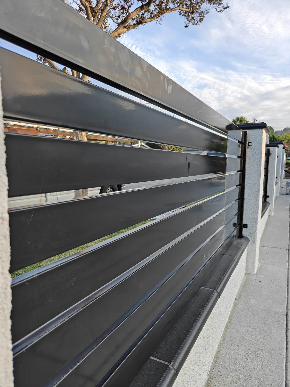 Close-up of black powder-coated horizontal slat spacing — Apexguard Fence project detail, La Puente, CA