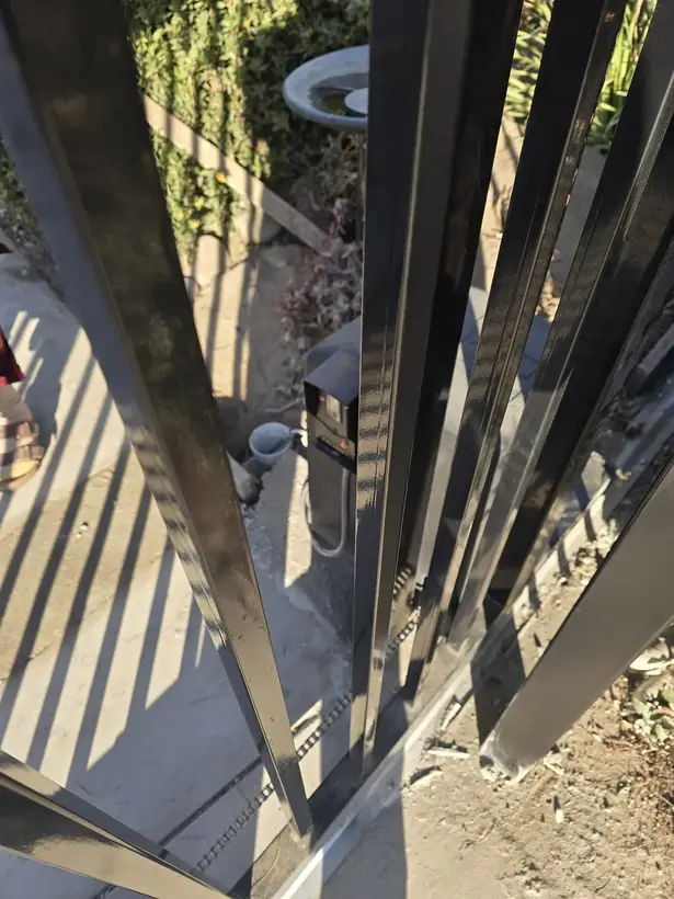 Automatic sliding gate operator and safety sensor installed by Apexguard Fence