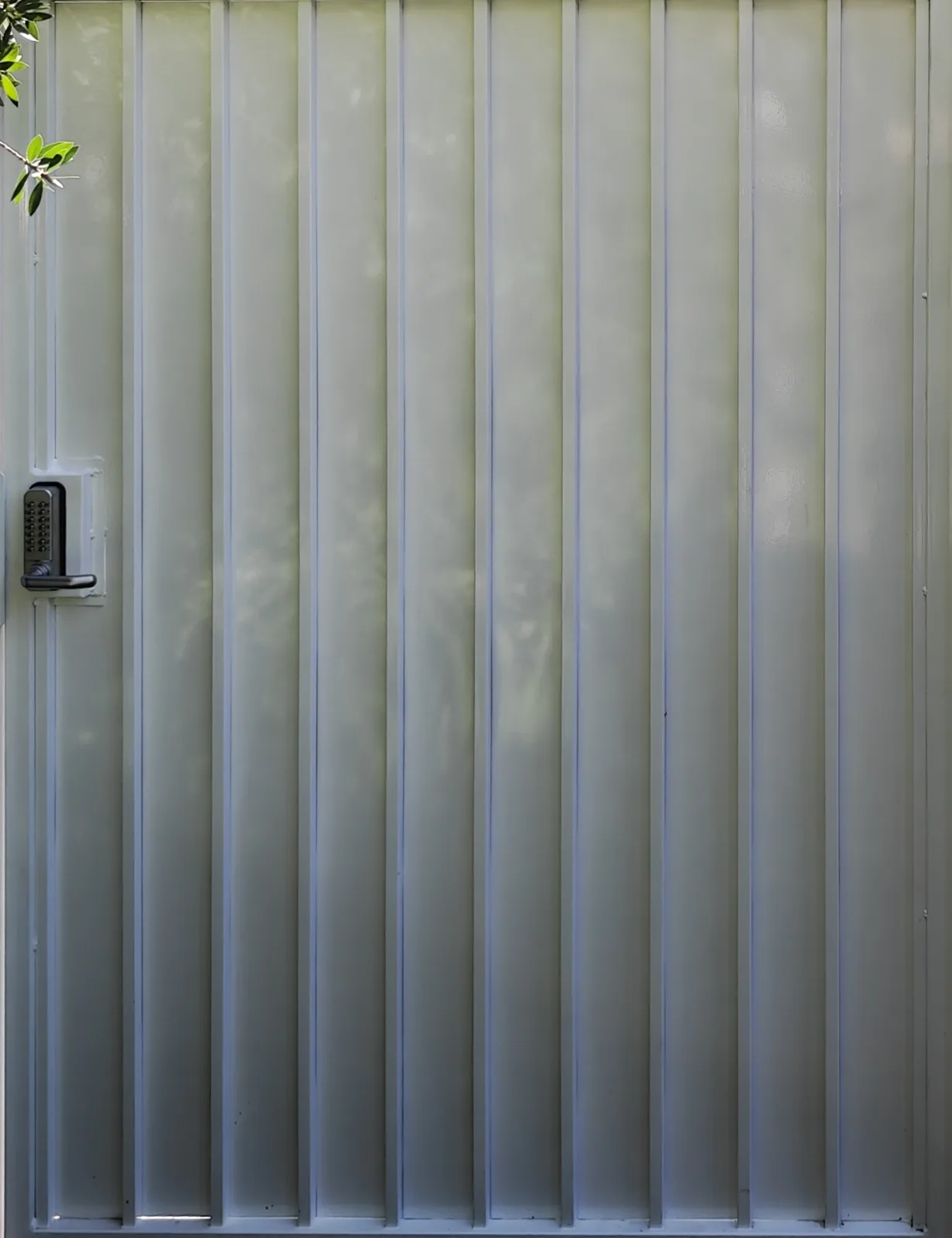 Ribbed steel panel face of the white walk gate with keypad lock in West Covina, CA by Apexguard Fence