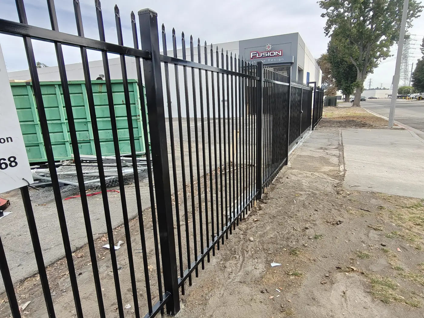 7 ft steel security fence protecting a sign manufacturer's material yard and containers in Whittier, CA