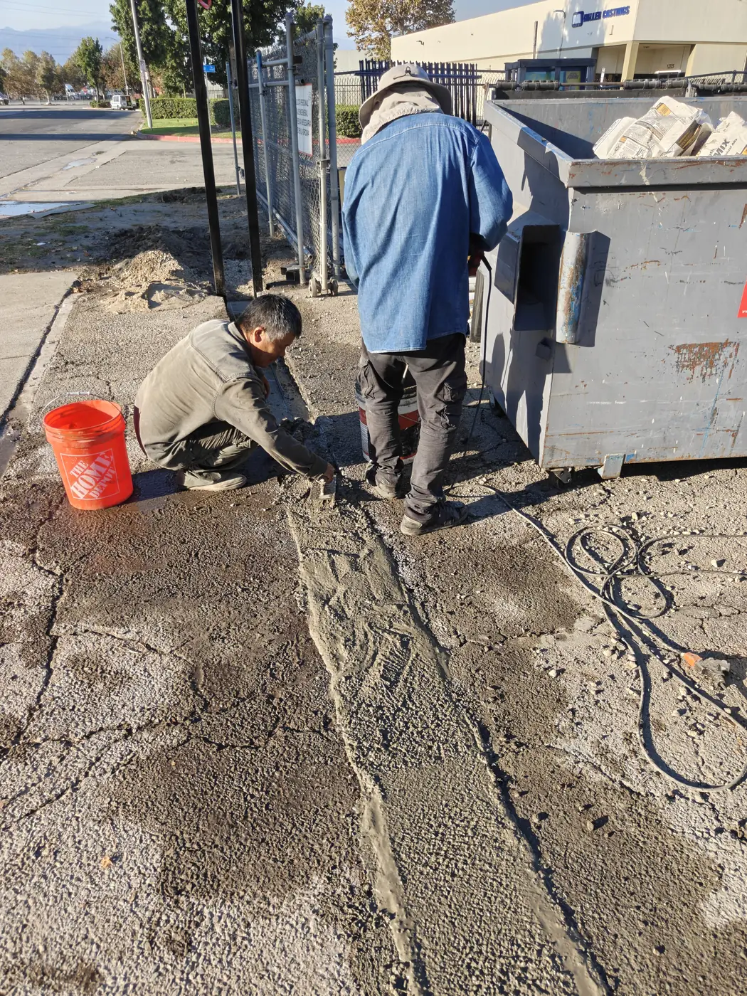 Apexguard Fence crew pouring the concrete footing and mow curb for a 7 ft commercial fence in Whittier, CA
