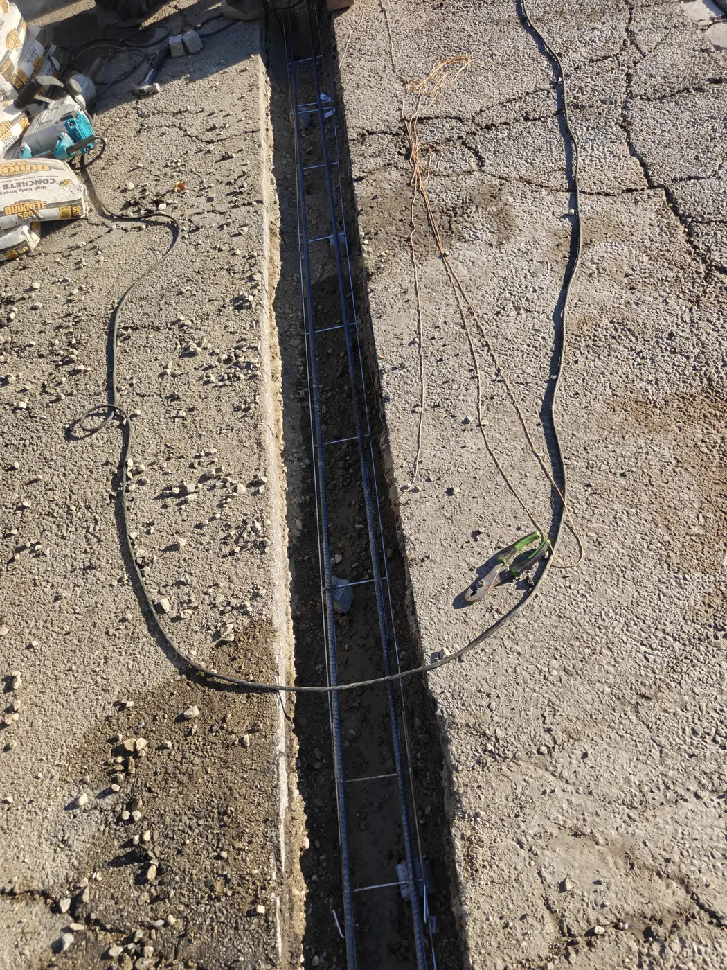 Continuous rebar laid in an open trench for a commercial fence footing in Whittier, CA