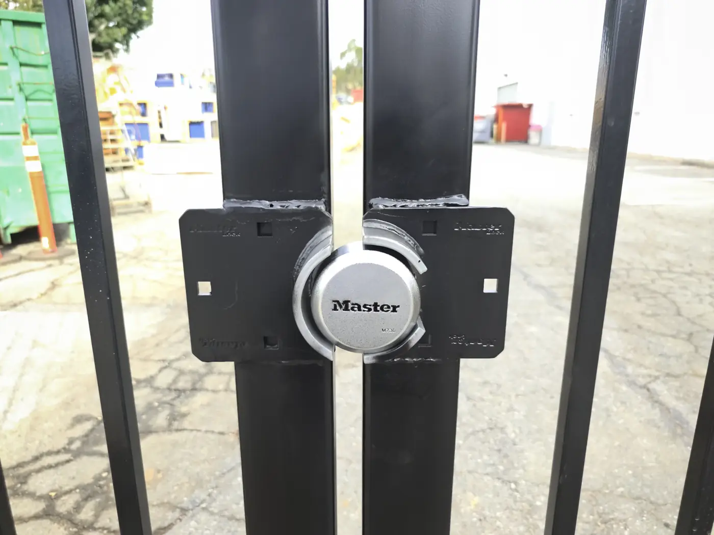Protected lock box and padlock detail on a commercial steel swing gate in Whittier, CA