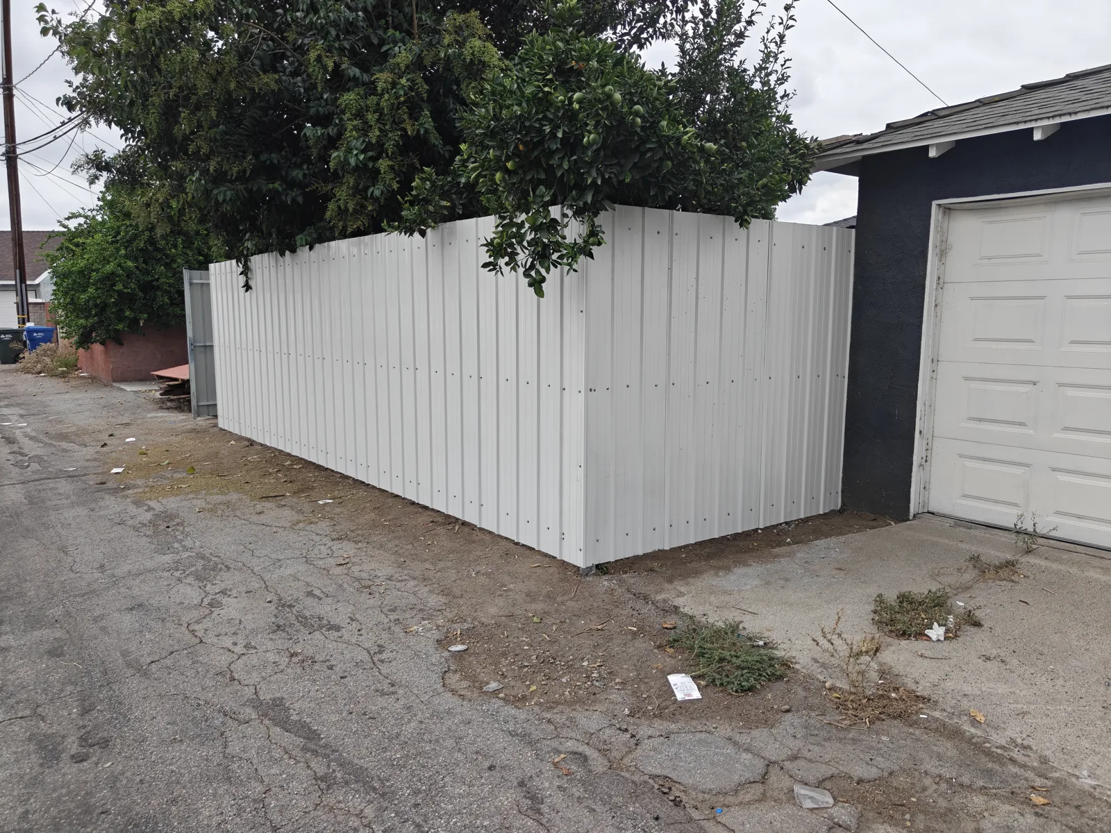 7 ft white corrugated steel panel privacy fence along an alley — a real Apexguard Fence project in Whittier, CA