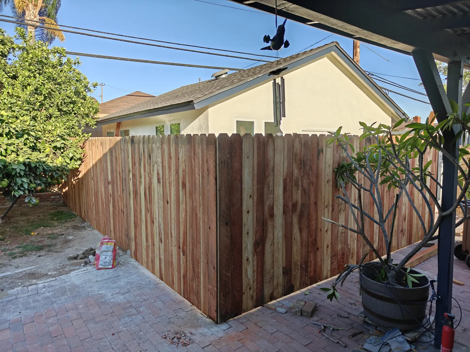 Dog-ear wood privacy fence wrapping a backyard corner in Claremont, CA by Apexguard Fence